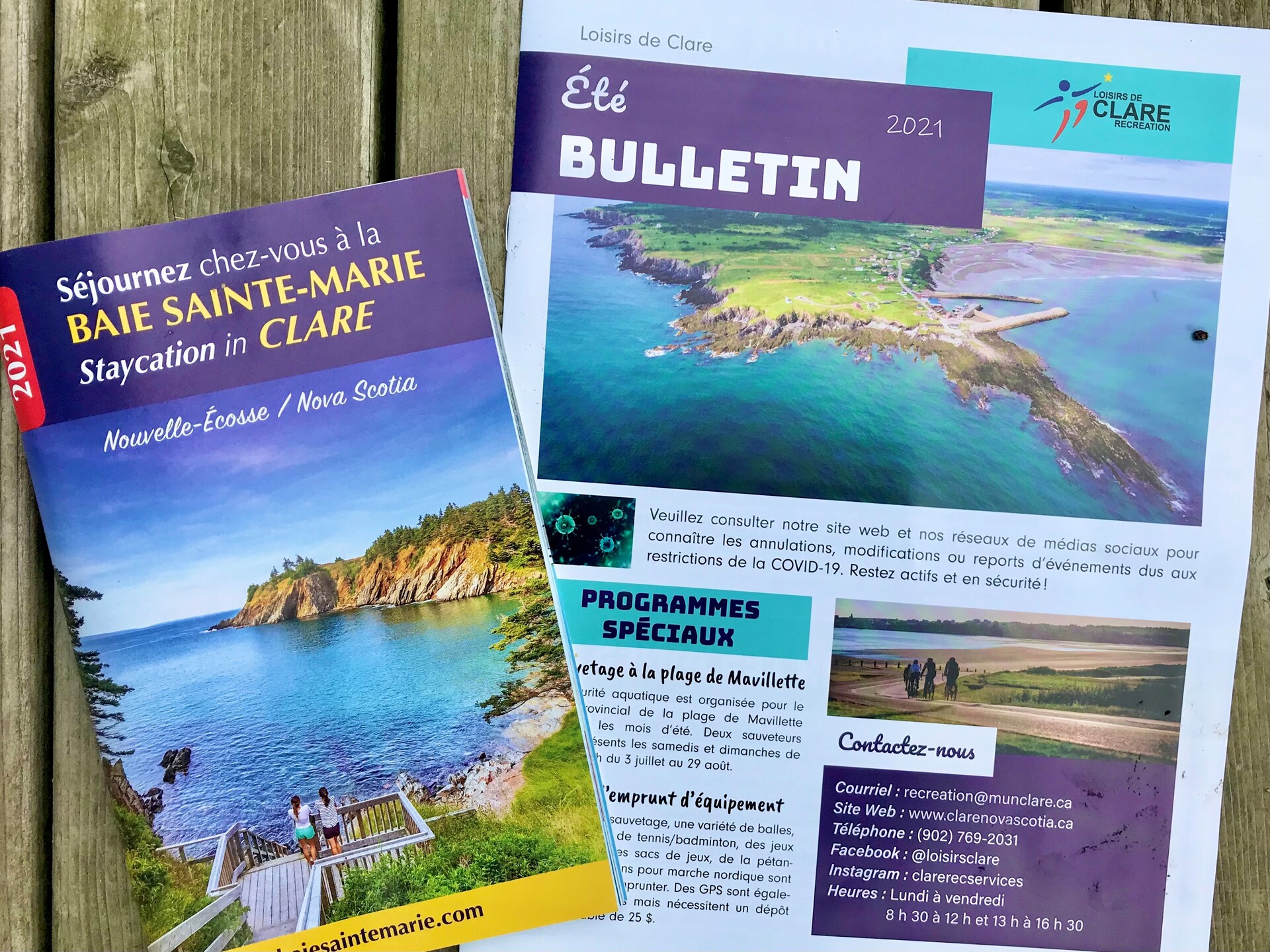A photo of the 2021 Clare visitor's guide and the Clare Recreation newsletter